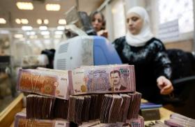 Workers package Syrian pound currency notes at the Syrian Central Bank in Damascus following the fall of the Assad regime in December 2024 - source: Reuters