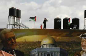 A police officer loyal to the Palestinian Authority stands guard on a wall at PA headquarters in Ramallah in 2007 - source: Reuters