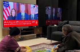 A photo of Palestinians watching President Biden's announcement of the Gaza ceasefire deal, January 2025.
