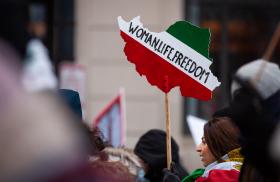Iranian-American demonstrators hold signs at a protest in Washington, DC - source: Reuters