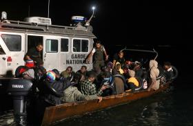 A Tunisian maritime patrol boat intercepts a migrant boat in the Mediterranean - source: Reuters