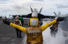 Flight deck crew issues commands to a U.S. Navy F/A-18 Super Hornet prior to launch from the carrier USS Harry S. Truman - source: Department of Defense