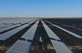 A worker monitors panels in a Saudi solar energy field - source: Kingdom of Saudi Arabia