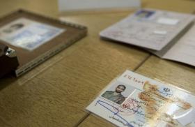 Iranian officials display what they claim to be counterfeit identification documents seized from accused spies - source: Reuters