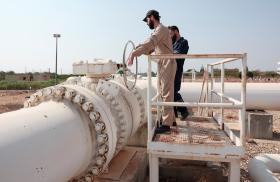 Photo of workers at a natural gas pipeline in Syria.