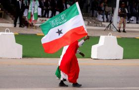 A man carries a Somilaland flag in a parade in Hargeisa - source: Reuters