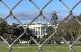 The White House photographed from behind a chain-link fence - source: Reuters