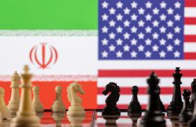 A photo illustration depicts chess pieces and the Iranian and U.S. flags - source: Reuters