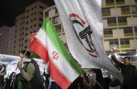 Iraqi protesters display Iranian and Popular Mobilization Forces militia flags at a demonstration in Baghdad following the killing of Iranian Supreme Leader Khamenei - source: Reuters