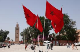 Moroccan flags fly in front of a mosque in Rabat - source: Reuters