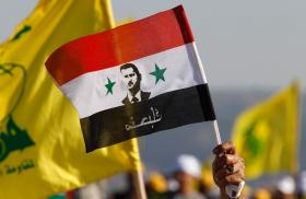 Protesters hold Syrian and Hezbollah flags